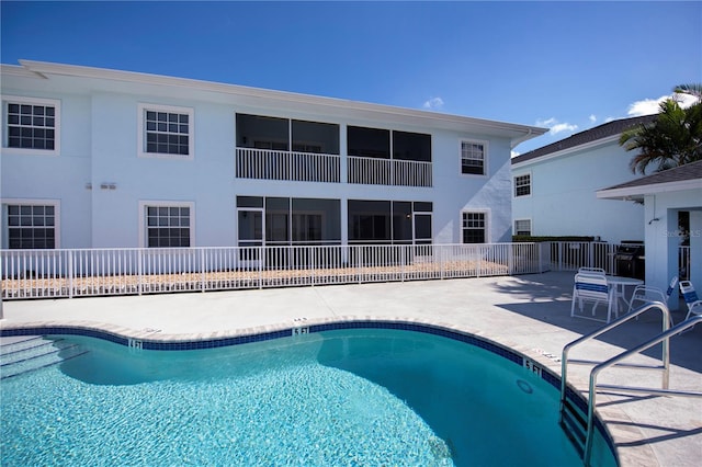 view of swimming pool with a patio area