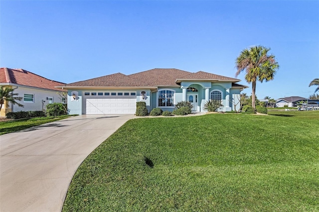 view of front of house featuring a garage and a front lawn