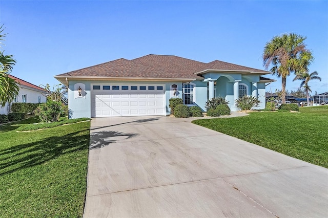 mediterranean / spanish-style house featuring stucco siding, driveway, a front lawn, and an attached garage