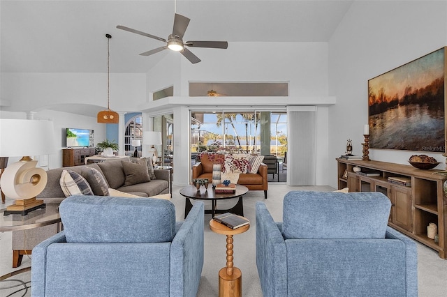 living room featuring light carpet, high vaulted ceiling, and ceiling fan