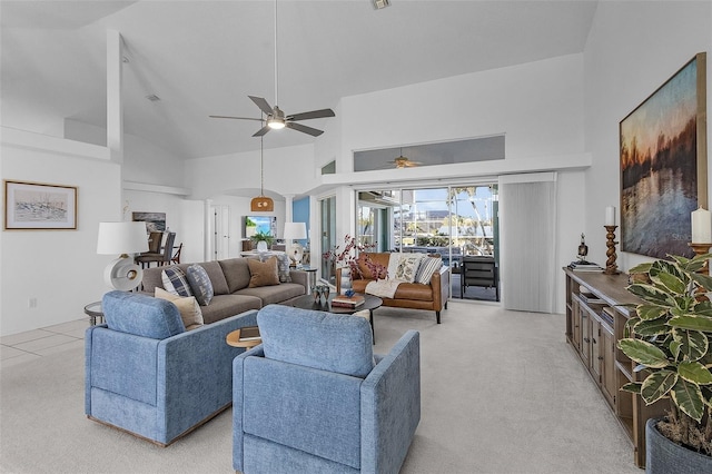 carpeted living room with ceiling fan and high vaulted ceiling