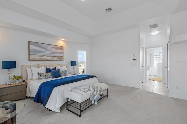 bedroom featuring light carpet, visible vents, and baseboards