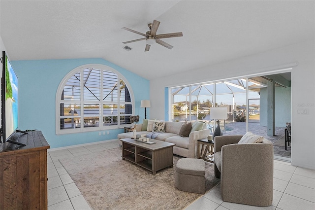 living room featuring vaulted ceiling, ceiling fan, and light tile patterned flooring