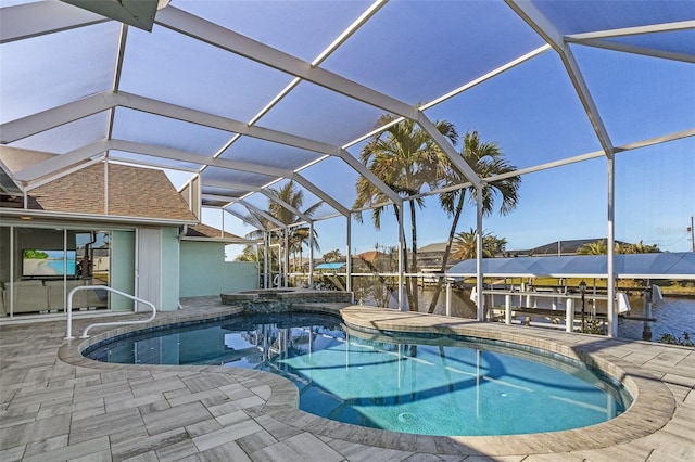 view of pool featuring an in ground hot tub, a dock, a lanai, a water view, and a patio area