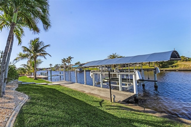 view of dock featuring a lawn and a water view