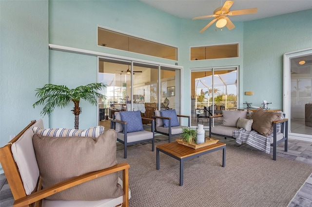 living room with ceiling fan and hardwood / wood-style flooring