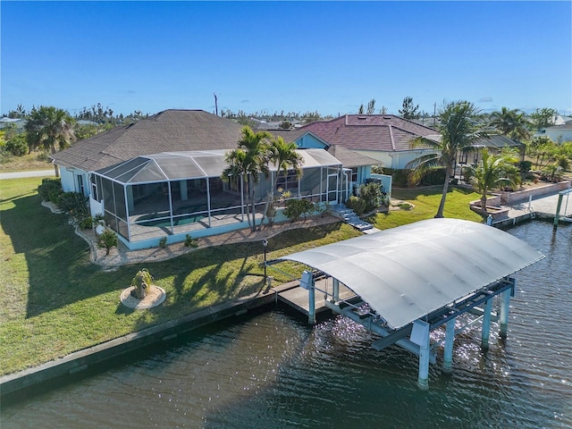 exterior space featuring a yard, a water view, and a lanai