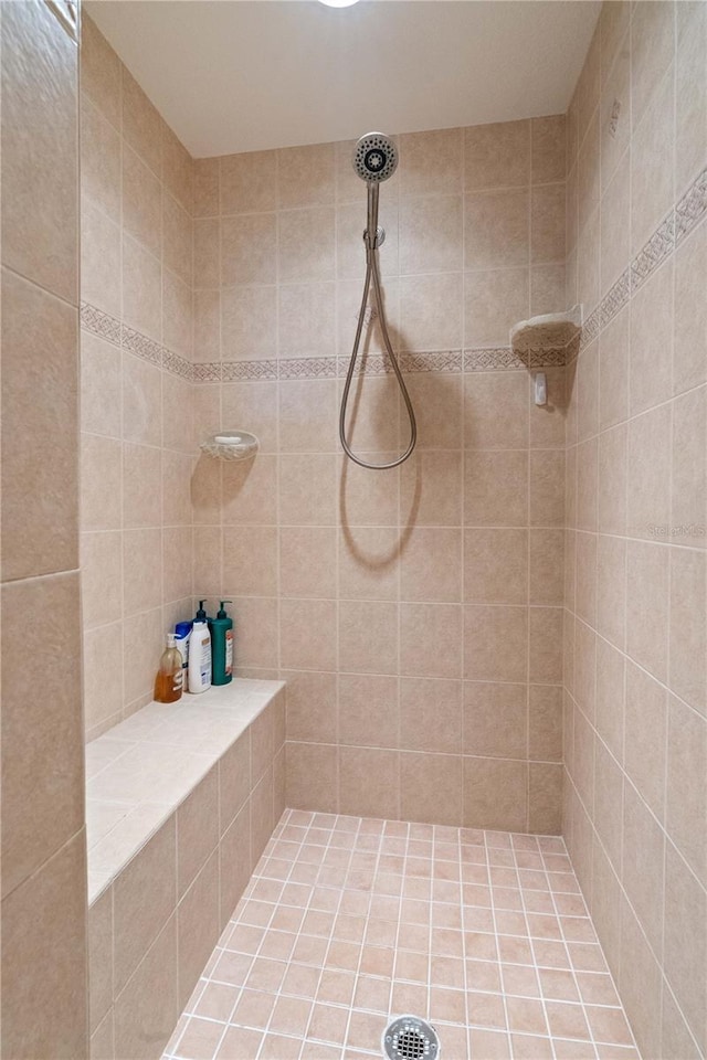 bathroom with a tile shower