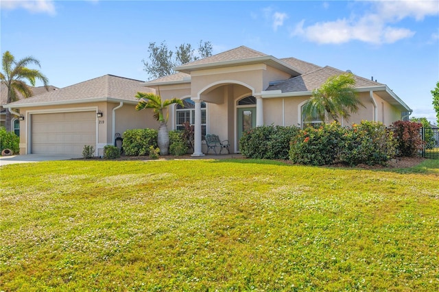 view of front of property with a garage and a front lawn