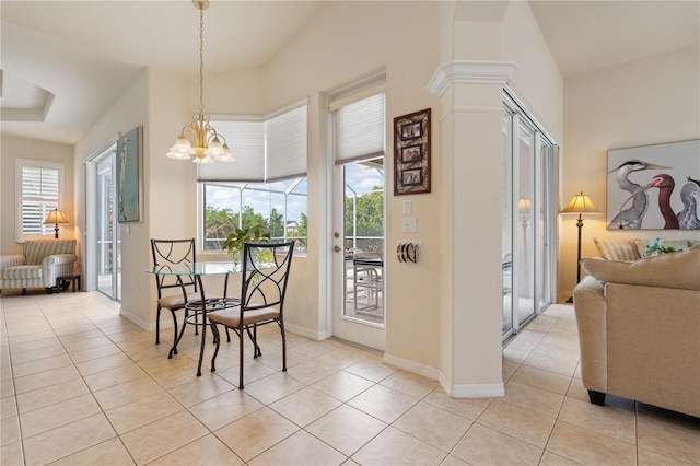 dining room featuring light tile patterned floors, baseboards, and an inviting chandelier