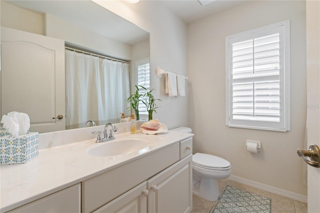 bathroom featuring toilet, baseboards, vanity, and tile patterned floors