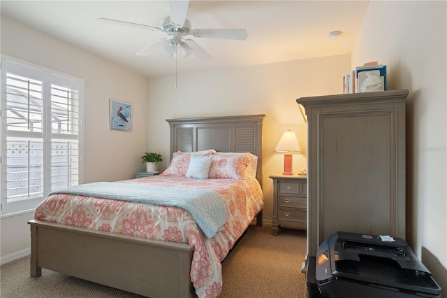 bedroom with ceiling fan, carpet flooring, and baseboards