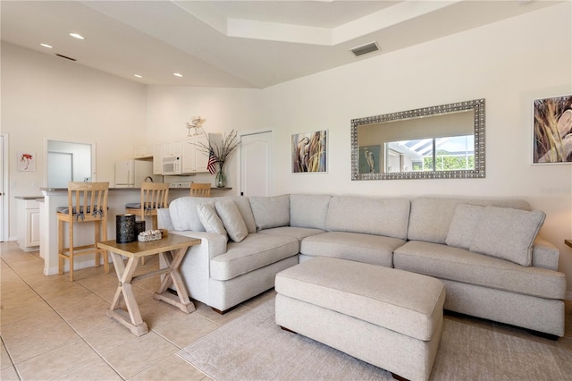 living room with light tile patterned floors, high vaulted ceiling, visible vents, and recessed lighting