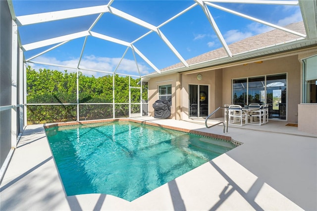 outdoor pool with a lanai and a patio