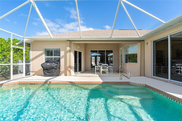 outdoor pool featuring a grill, glass enclosure, and a patio