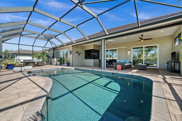 view of pool featuring outdoor lounge area, ceiling fan, a patio area, and a lanai