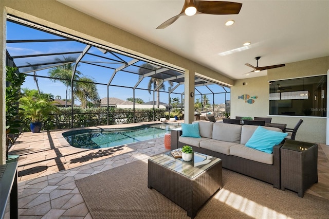 exterior space featuring an outdoor living space, ceiling fan, a patio, and glass enclosure