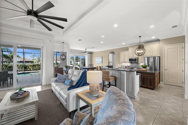 living room featuring light tile patterned floors, a wealth of natural light, and ornamental molding