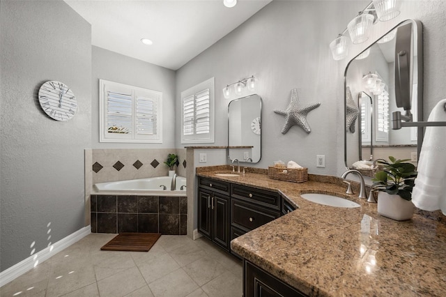 bathroom featuring tiled tub, tile patterned flooring, and vanity