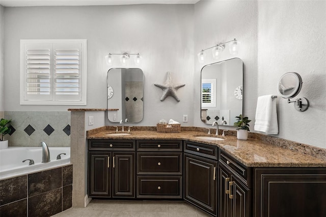 bathroom featuring tile patterned floors, vanity, a relaxing tiled tub, and a healthy amount of sunlight