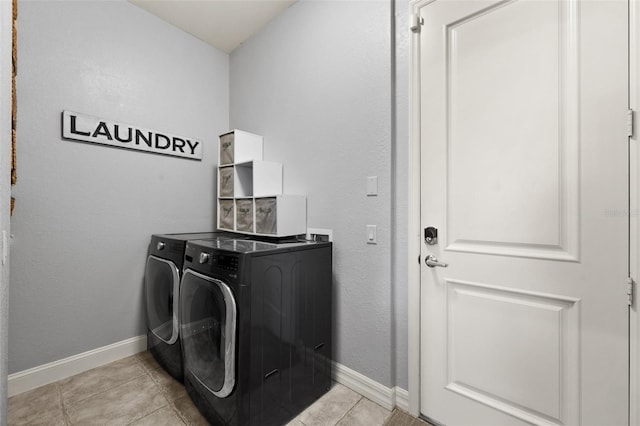 laundry area featuring separate washer and dryer and light tile patterned floors