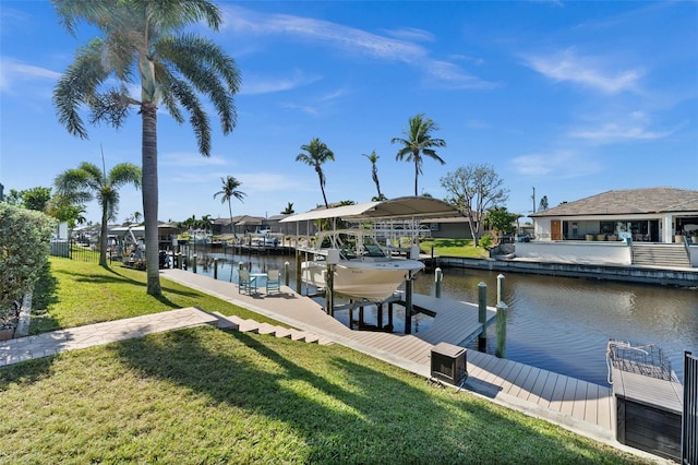 dock area with a lawn and a water view