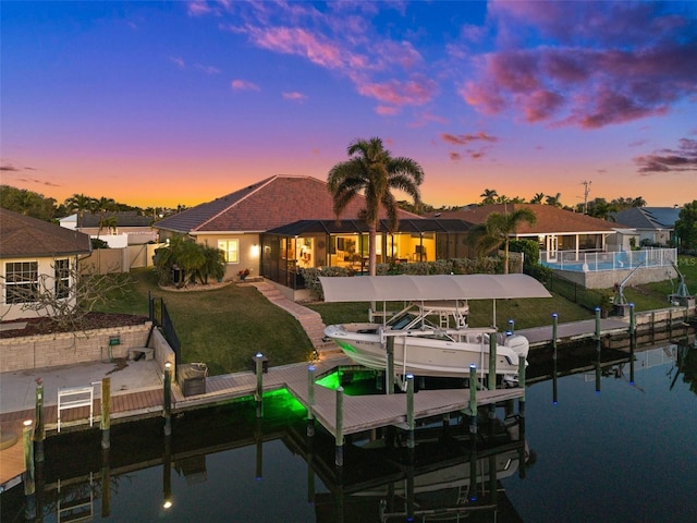 view of dock featuring a yard and a water view