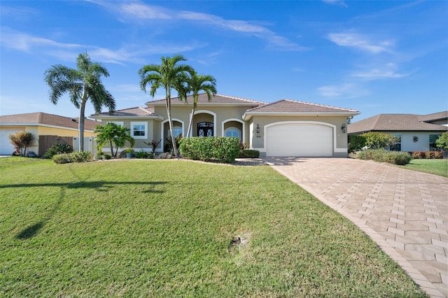 view of front of home with a front yard and a garage