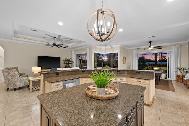 kitchen featuring dishwasher, decorative light fixtures, a spacious island, and dark stone countertops