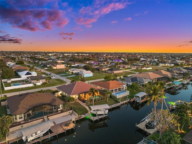 aerial view at dusk with a water view