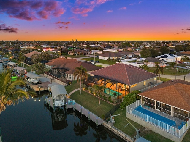 aerial view at dusk with a water view