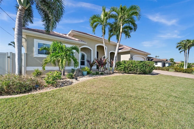 mediterranean / spanish home with a front yard and a garage