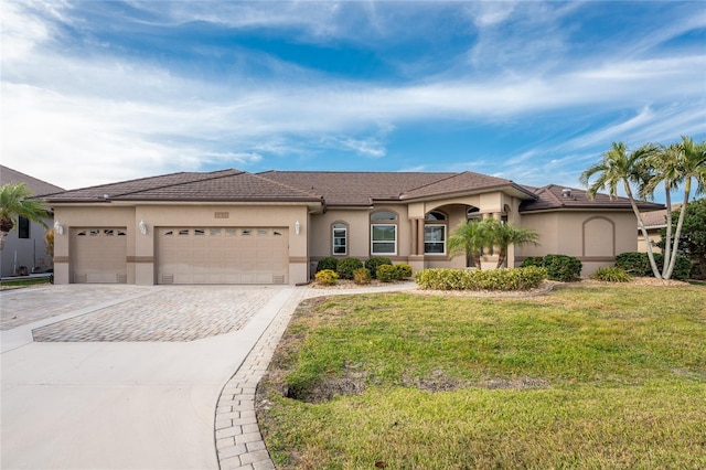 view of front of house featuring a front yard and a garage