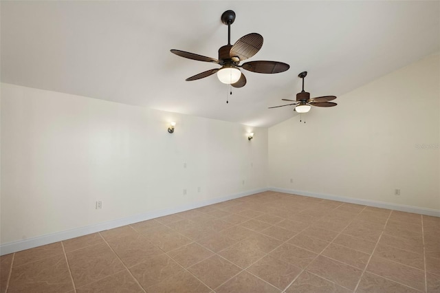 spare room with ceiling fan, baseboards, and vaulted ceiling