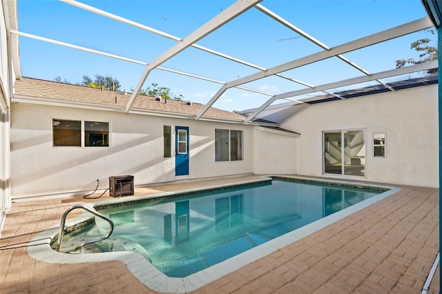 pool with glass enclosure and a patio