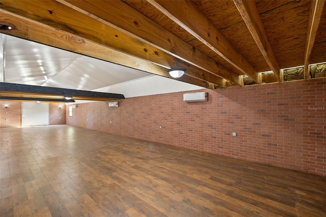 interior space with brick wall and wood finished floors