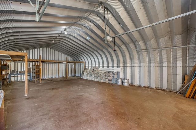 miscellaneous room with vaulted ceiling and concrete flooring