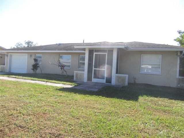 view of front of property featuring a garage and a front lawn