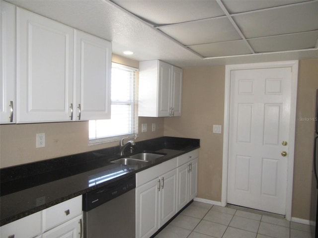 kitchen with white cabinets, dishwasher, light tile patterned floors, and sink