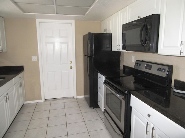 kitchen featuring light tile patterned floors, white cabinetry, and stainless steel range with electric stovetop