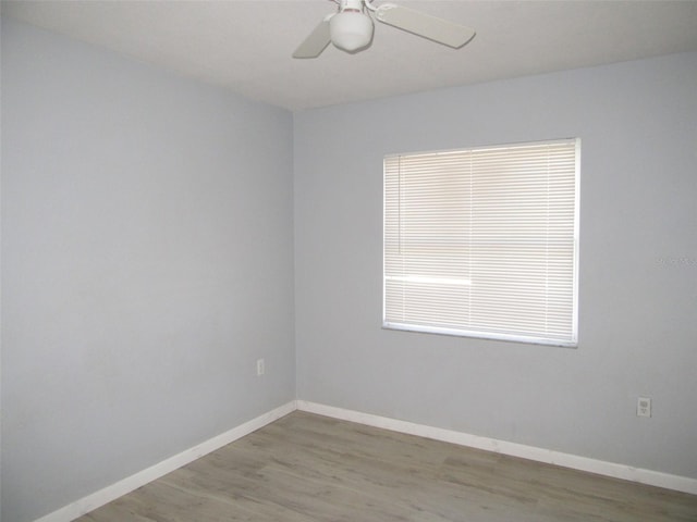 empty room with hardwood / wood-style flooring and ceiling fan