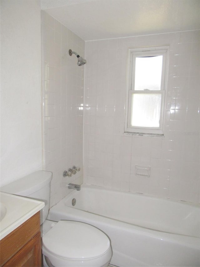 full bathroom featuring vanity, toilet, and tiled shower / bath combo