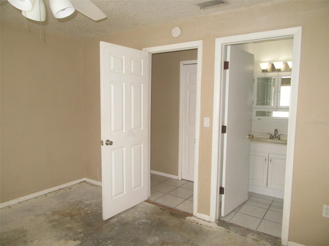 interior space with a textured ceiling and sink