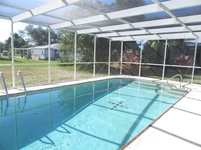 view of swimming pool featuring a lanai and a yard