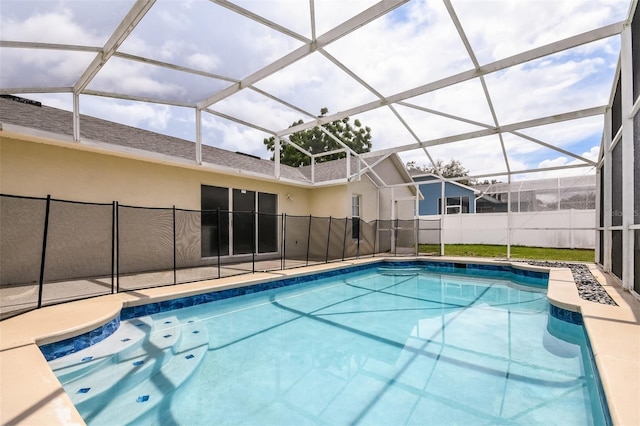 view of swimming pool featuring glass enclosure