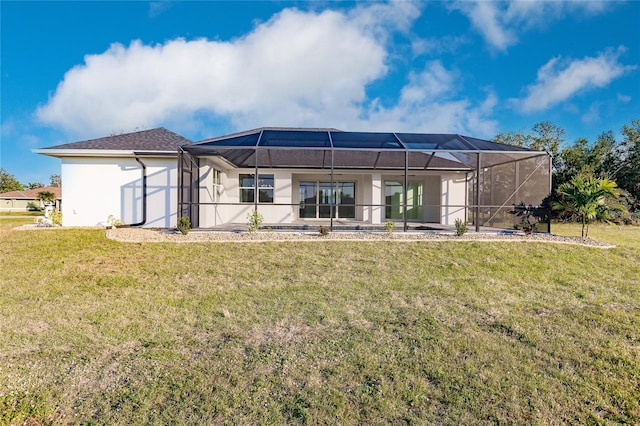 back of property with a yard and glass enclosure