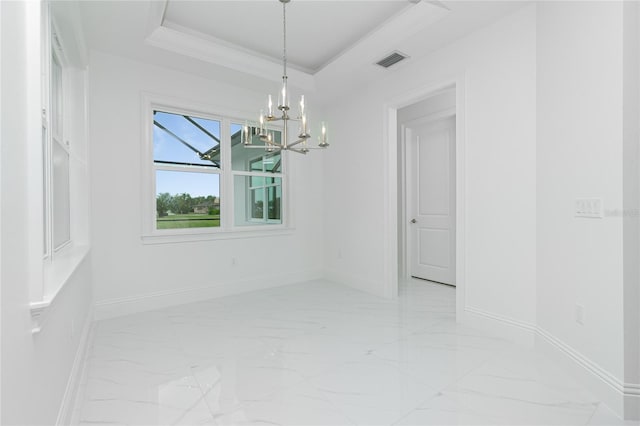 unfurnished dining area featuring an inviting chandelier, a tray ceiling, and crown molding