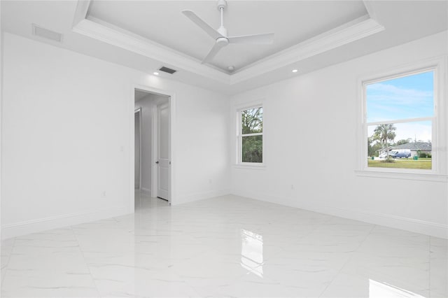 unfurnished room featuring crown molding, ceiling fan, and a raised ceiling