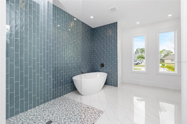 bathroom with separate shower and tub and tile walls