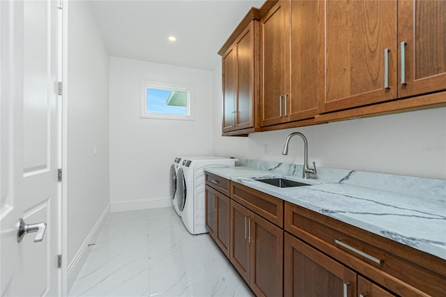 laundry room featuring cabinets, washing machine and dryer, and sink